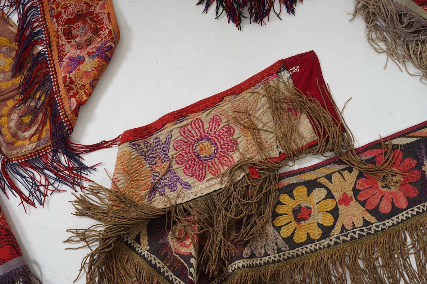Five various sized late 19th / early 20th century Usbek Saye Gosha (V shaped) Suzani silk embroidered bridal yurt wall hangings, usually forming part of a dowry, two with later fringing, longest 172cm. Condition - some f